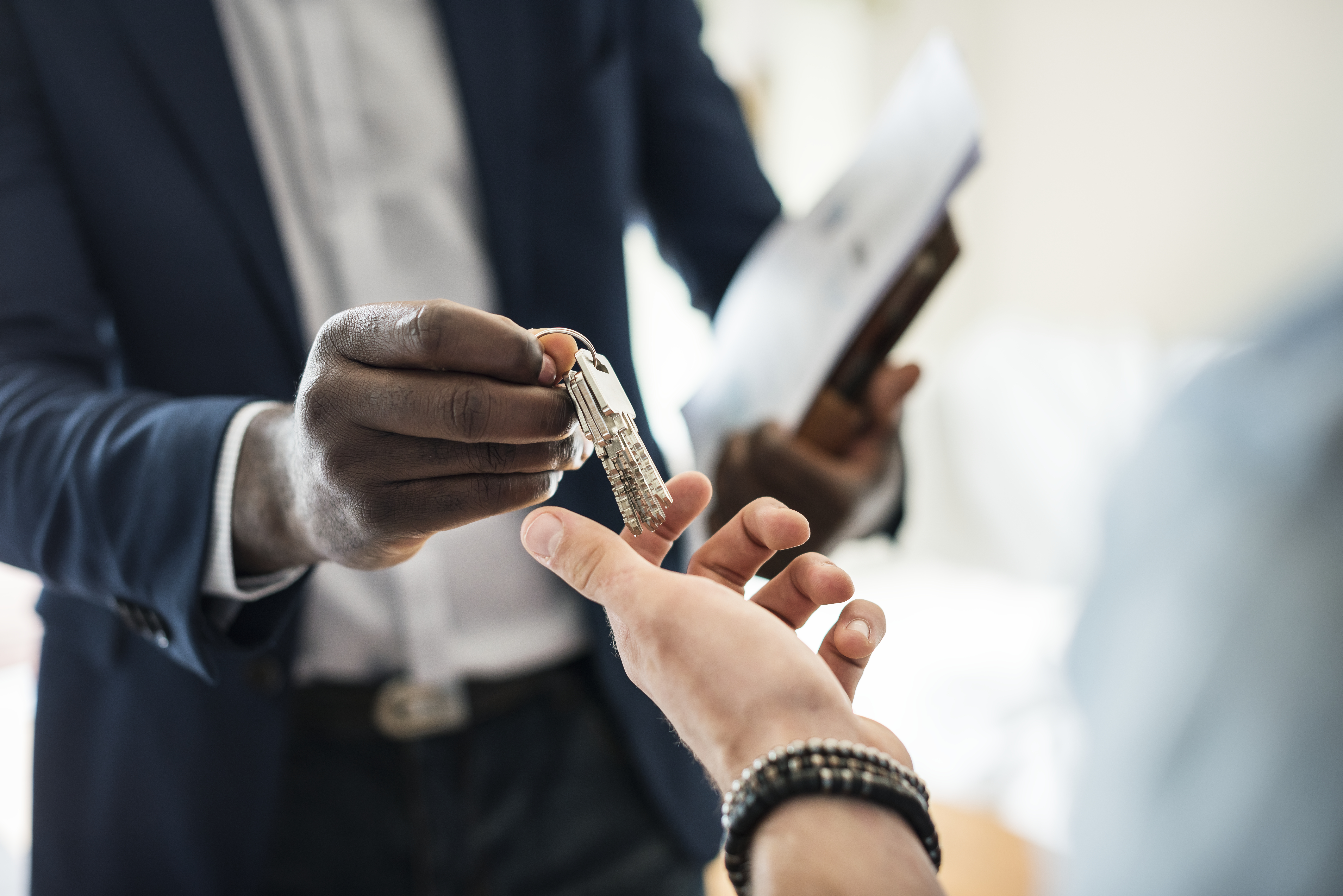 Estate agent handing the house key to a client