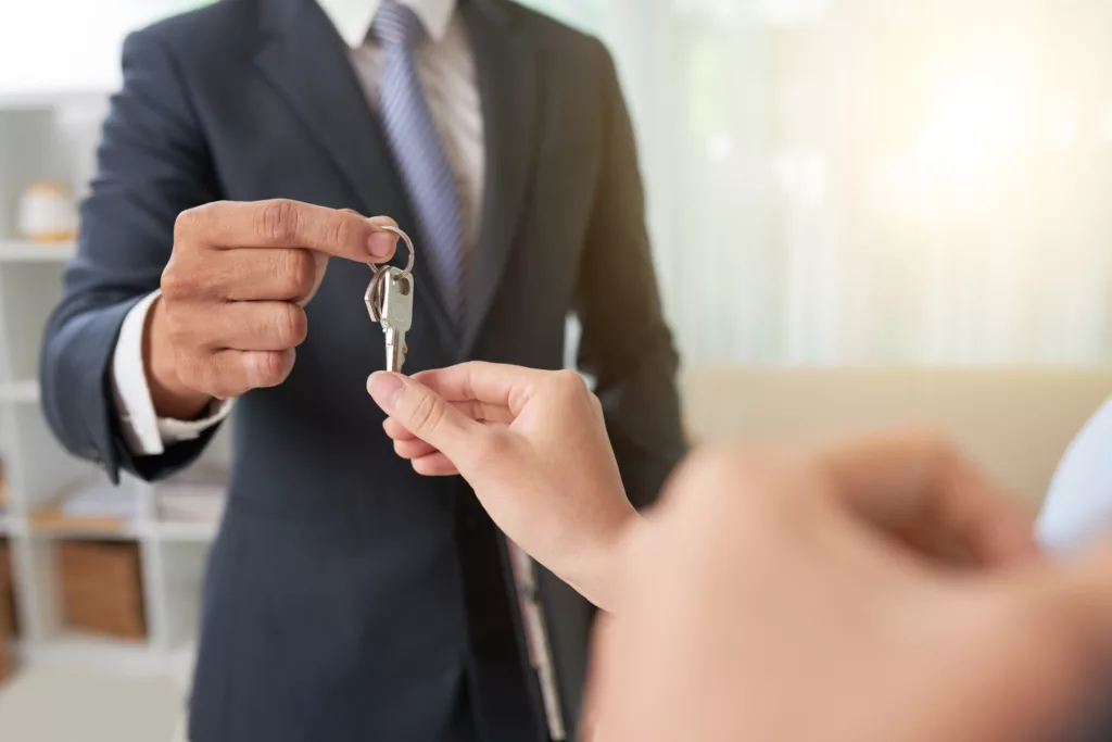 Landlord handing over keys to tenant